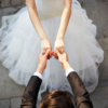 young asian newlywed couple wearing wedding dress dancing in open ground, high angle view.